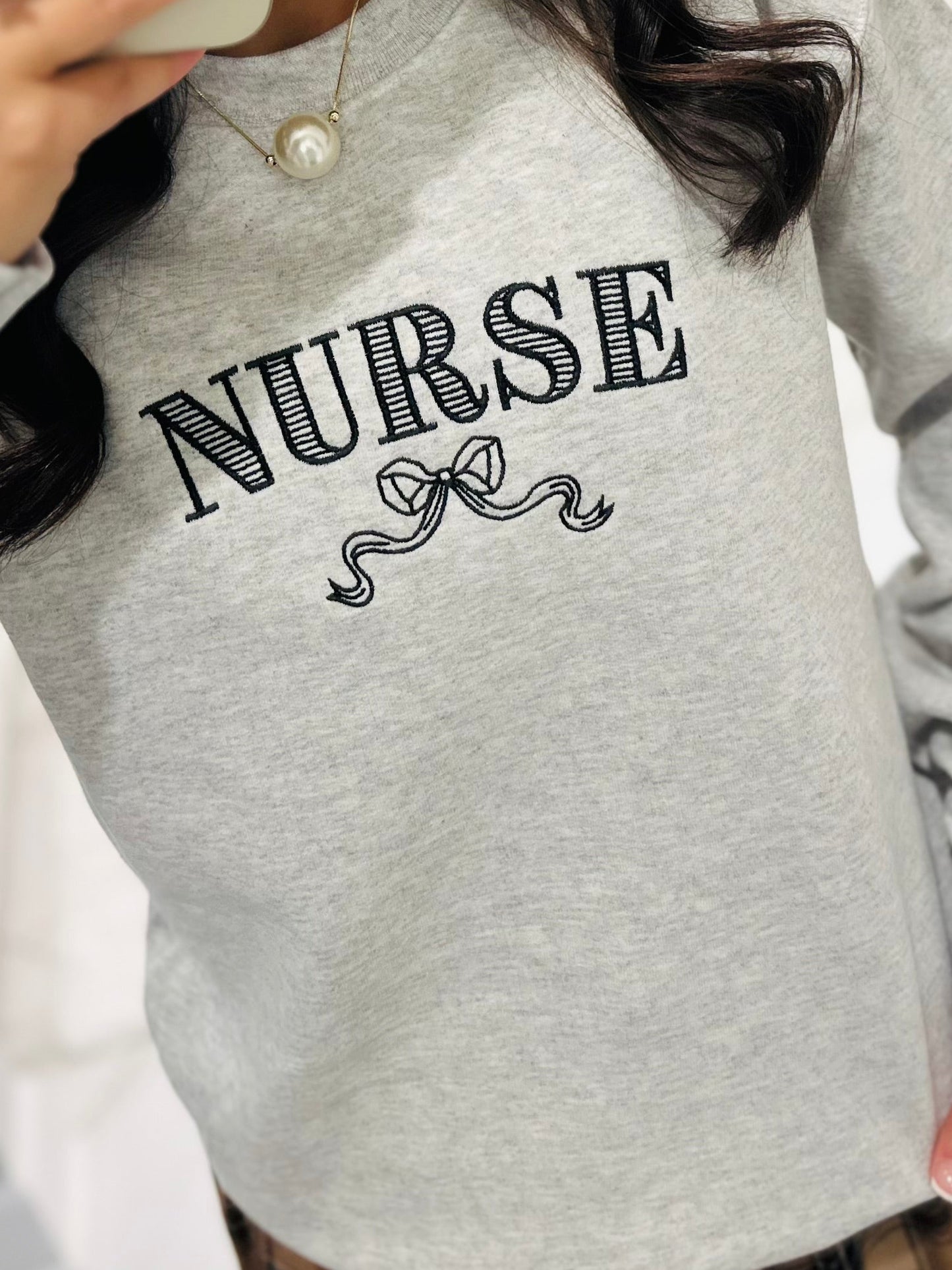 The Nurse Bow Embroidered Crewneck