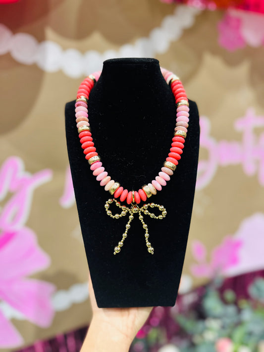 The Posie Pink + Gold Wide Bead Bow Pendant Necklace
